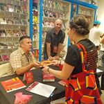  Josef, author of Nain Rouge, is signing copies of the book. Don't miss the raffle for one of 10 Special Edition copies! #Detroit #indie #authors #nainrouge #vaultofmidnight #madeinmichigan #books #booksigning #photoop #thomsonshore #book #printer #publisher #comics #novels #folkteller #stories 